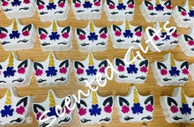 Load image into Gallery viewer, Unicorn jead shaped bath bomb scented in unicorn sparkles A fresh, juicy, sugar laden blend of papaya, peach, mandarin, raspberry, grape and pineapple, with sweet hints of coconut and jasmine all rolled up with white musk and amber. A white decorated bomb with coloured embeds.