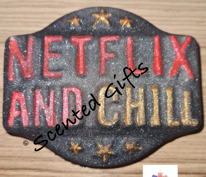 Netflix and Chill Bath Bomb  A black shimmer airbrushed plaque shaped bath bomb with raised text ‘Netflix and chill’ hand painted details and coloured bath bomb scented in coco mango.