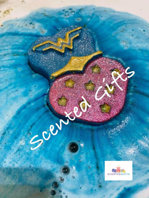 Wonder bath bomb - a vibrant teal with hand painted decor and hidden red and yellow fragranced in lady million.