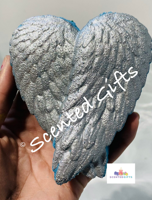 Fallen Angel winged shaped bath bomb, a pair of teal coloured wings with silver painted decoration. Fragranced in blush naked lenor fabric conditioner dupe.