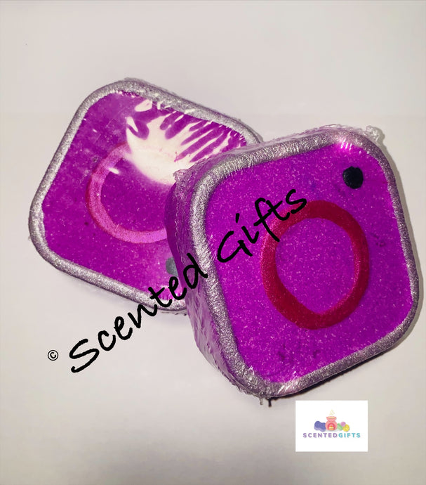 Insta Cam bath bomb A pink Instagram shaped bath bomb with mica detail and hidden colours scented in black raspberry vanilla. 